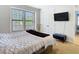Bright bedroom with large windows, TV, and walk-in closet at 8264 Dunham Station Dr, Tampa, FL 33647