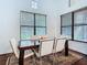 Bright dining room featuring a modern table, white chairs, and natural light from large windows at 8264 Dunham Station Dr, Tampa, FL 33647