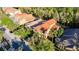 Stunning home with a red tile roof surrounded by lush greenery and trees in a peaceful residential neighborhood at 8264 Dunham Station Dr, Tampa, FL 33647