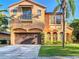 Two-story home with a brown garage door, a red tile roof, arched windows, and manicured landscaping at 8264 Dunham Station Dr, Tampa, FL 33647