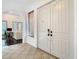 Bright foyer with tiled floors, white double doors, and arched entryway leading to the living area at 8264 Dunham Station Dr, Tampa, FL 33647
