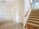 Bright entryway with tile flooring and a staircase, creating a welcoming first impression at 8264 Dunham Station Dr, Tampa, FL 33647