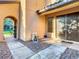 Welcoming covered front porch with double doors, tiled floors, decorative rock, and an arched entry at 8264 Dunham Station Dr, Tampa, FL 33647