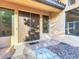 Close-up of double front doors with windows, tiled floors, decorative rock, and neutral exterior paint at 8264 Dunham Station Dr, Tampa, FL 33647