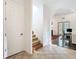 Hallway features tile floors leading to carpeted stairs and an arched entryway to another room at 8264 Dunham Station Dr, Tampa, FL 33647