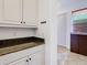 Hallway with white cabinets and granite countertops, offering a clean and functional space at 8264 Dunham Station Dr, Tampa, FL 33647