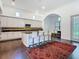 Open-concept kitchen features a large island with seating, dark wood floors, and bright lighting at 8264 Dunham Station Dr, Tampa, FL 33647