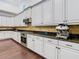 Kitchen with stainless steel oven, espresso machine, and granite countertops at 8264 Dunham Station Dr, Tampa, FL 33647