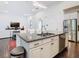 Kitchen island with seating and stainless steel dishwasher, open to living area at 8264 Dunham Station Dr, Tampa, FL 33647