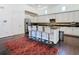 Bright kitchen features a center island with seating and dark wood floors at 8264 Dunham Station Dr, Tampa, FL 33647