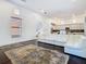 Bright living room with tall ceilings, hardwood floors, white sofa, kitchen access, and large windows at 8264 Dunham Station Dr, Tampa, FL 33647