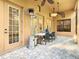 Covered patio with tile flooring, ceiling fans, and outdoor seating area at 8264 Dunham Station Dr, Tampa, FL 33647