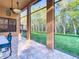 Screened-in patio providing outdoor views, with tile flooring and a ceiling fan at 8264 Dunham Station Dr, Tampa, FL 33647