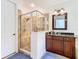 Modern walk-in shower with tile surround and glass door in a beautifully designed bathroom at 8264 Dunham Station Dr, Tampa, FL 33647