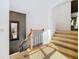 Carpeted staircase with wood and iron banister leads to upper level, complemented by wall mirror at 8264 Dunham Station Dr, Tampa, FL 33647