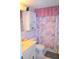 Bathroom featuring shower with floral print curtain and cabinet for bathroom essentials at 960 Virginia St # 205, Dunedin, FL 34698