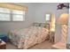 Cozy bedroom with patterned comforter and bright natural light from large window at 960 Virginia St # 205, Dunedin, FL 34698