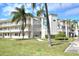 Charming condo building featuring multiple floors, balconies, and well-maintained landscaping at 960 Virginia St # 205, Dunedin, FL 34698