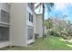 Exterior of building showing maintained lawns, mature landscaping, and architectural details of the community at 960 Virginia St # 205, Dunedin, FL 34698