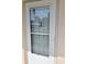 A close up of the front door with secure glass and visible address at 960 Virginia St # 205, Dunedin, FL 34698