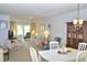 Comfortable living room with floral sofa and tropical print curtains lets in natural light at 960 Virginia St # 205, Dunedin, FL 34698