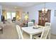 Spacious open-concept living and dining area with elegant chandelier and modern furniture at 960 Virginia St # 205, Dunedin, FL 34698
