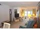 Comfortable living room with floral sofa and tropical print curtains lets in natural light at 960 Virginia St # 205, Dunedin, FL 34698