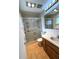 A full bathroom features tile flooring, vanity with sink, medicine cabinet, and a glass-enclosed shower at 10063 40Th N St # 3, Pinellas Park, FL 33782