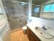Bathroom with a shower, tile walls, and a vanity with a sink and wooden drawers at 10063 40Th N St # 3, Pinellas Park, FL 33782
