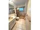 Cozy bathroom featuring tiled floor, large mirror and bathtub with shower at 10063 40Th N St # 3, Pinellas Park, FL 33782