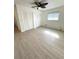 Spacious bedroom featuring modern floors, ceiling fan, and ample closet space at 10063 40Th N St # 3, Pinellas Park, FL 33782