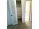 Louvered closet door with white wire shelving and hardwood floor at 10063 40Th N St # 3, Pinellas Park, FL 33782