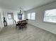 Bright dining area featuring tiled floors and a modern light fixture at 10063 40Th N St # 3, Pinellas Park, FL 33782