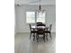 Cozy dining area with a modern chandelier and a window with a view at 10063 40Th N St # 3, Pinellas Park, FL 33782
