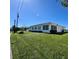 Exterior shot of house with well-maintained lawn and various windows and outdoor features at 10063 40Th N St # 3, Pinellas Park, FL 33782
