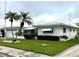Beautiful home featuring a well-maintained lawn, vibrant landscaping, and a charming exterior design at 10063 40Th N St # 3, Pinellas Park, FL 33782