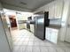 View of kitchen with stainless steel appliances, tiled floors, and white cabinets at 10063 40Th N St # 3, Pinellas Park, FL 33782