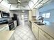 Bright kitchen with stainless steel appliances, tiled floors, and white cabinets at 10063 40Th N St # 3, Pinellas Park, FL 33782