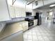 Charming kitchen featuring white cabinets, stainless steel appliances, and spacious countertops at 10063 40Th N St # 3, Pinellas Park, FL 33782