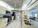 Bright kitchen with stainless steel appliances, tiled floors, and white cabinets at 10063 40Th N St # 3, Pinellas Park, FL 33782