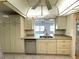 Kitchen area featuring white cabinets, stainless steel appliances, and a double sink at 10063 40Th N St # 3, Pinellas Park, FL 33782