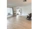 Bright living room with wood floors, large window, and front door at 10063 40Th N St # 3, Pinellas Park, FL 33782
