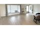 Bright living room with wood floors, large window, and front door at 10063 40Th N St # 3, Pinellas Park, FL 33782