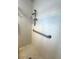 Shower stall with white tile, mosaic floor, grab bar, and shelving unit at 10063 40Th N St # 3, Pinellas Park, FL 33782