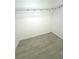A walk-in closet with laminate flooring and a wire rack for organizing clothes and accessories at 10063 40Th N St # 3, Pinellas Park, FL 33782