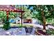 Landscaped backyard featuring a covered patio, lush landscaping and a detached garage at 1011 W Charter St, Tampa, FL 33602
