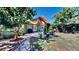 Relaxing backyard featuring a covered patio, lush greenery, and a stone pathway at 1011 W Charter St, Tampa, FL 33602