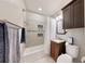 Bathroom featuring a tub and shower combination with decorative tiling and a dark wood vanity at 1011 W Charter St, Tampa, FL 33602