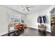 Bright bedroom featuring a desk, modern ceiling fan, and ample natural light from the large window at 1011 W Charter St, Tampa, FL 33602