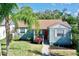 Charming single-story home with a well-manicured lawn and inviting, red front door at 1011 W Charter St, Tampa, FL 33602